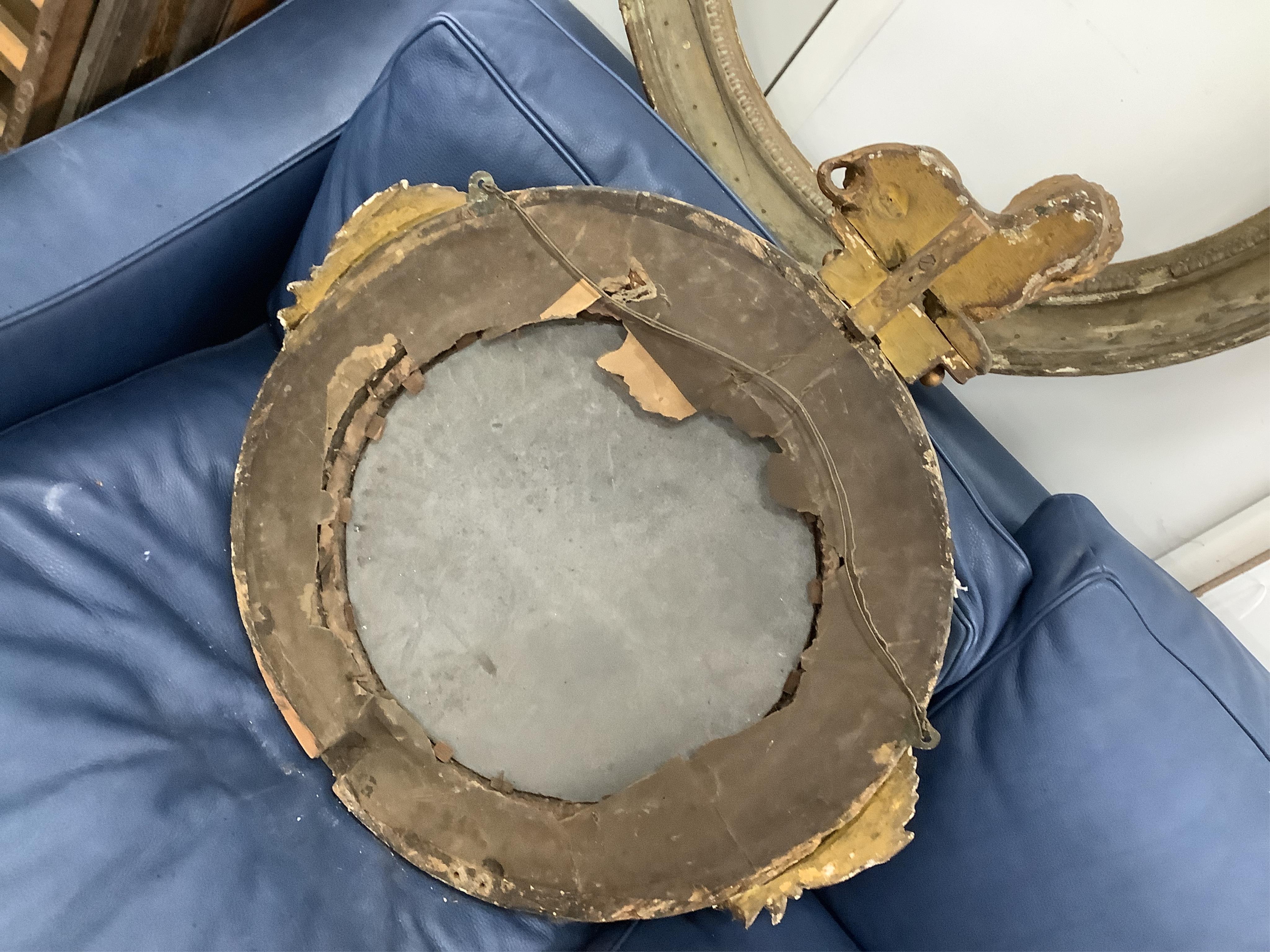 A Regency circular giltwood convex wall mirror with lion pediment, diameter 65cm a Regency convex mirror frame and Victorian girandole. Condition - poor
